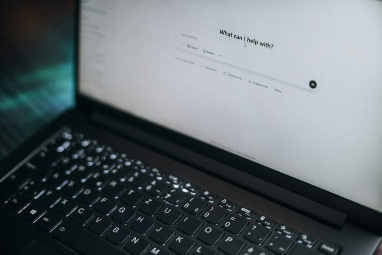 AI SEO vs Traditional SEO – What Actually Matters Now? 3 A laptop displays "what can i help with?"